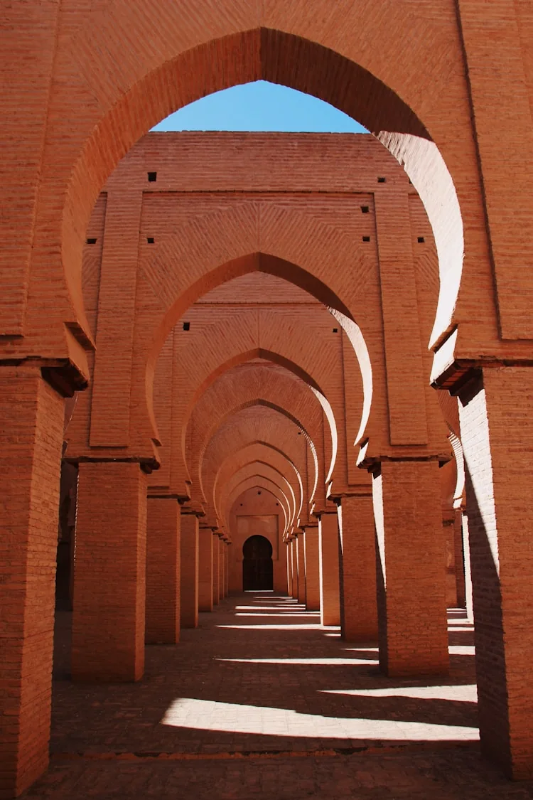 Long Moroccan arched passageway with warm light
