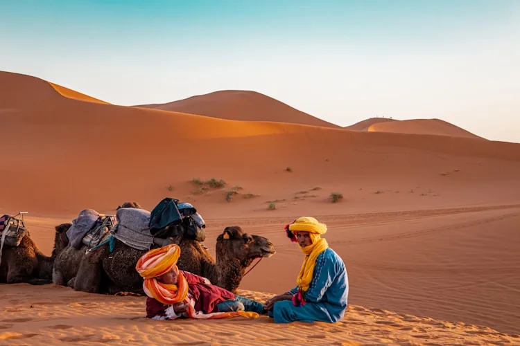 Travellers and guides in the Moroccan Sahara dunes