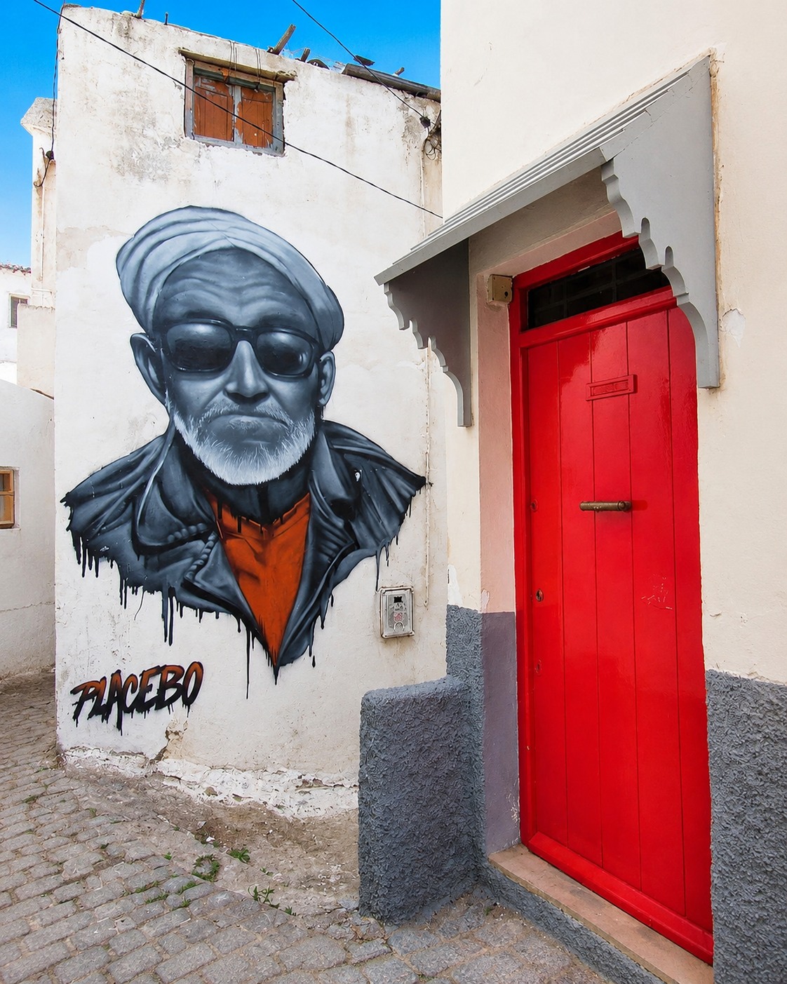 Portrait mural and red doorway in Azemmour