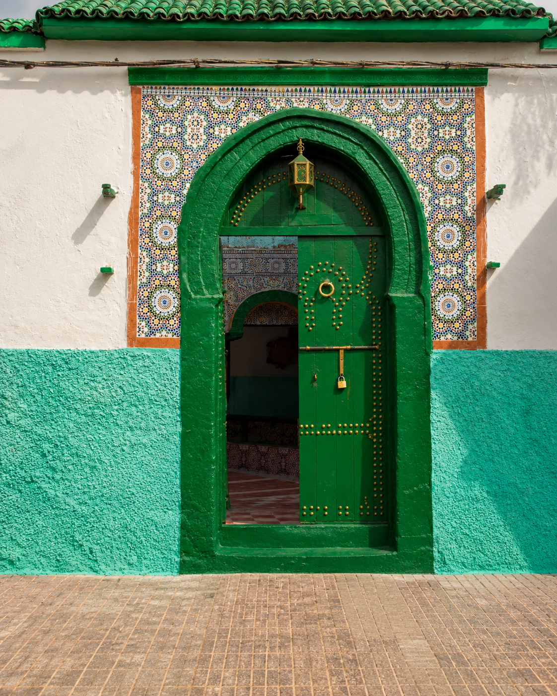 Green zellige-framed doorway and threshold in Azemmour