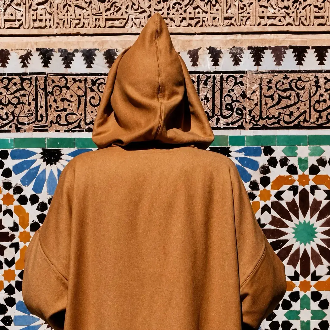 Figure in a djellaba against zellige