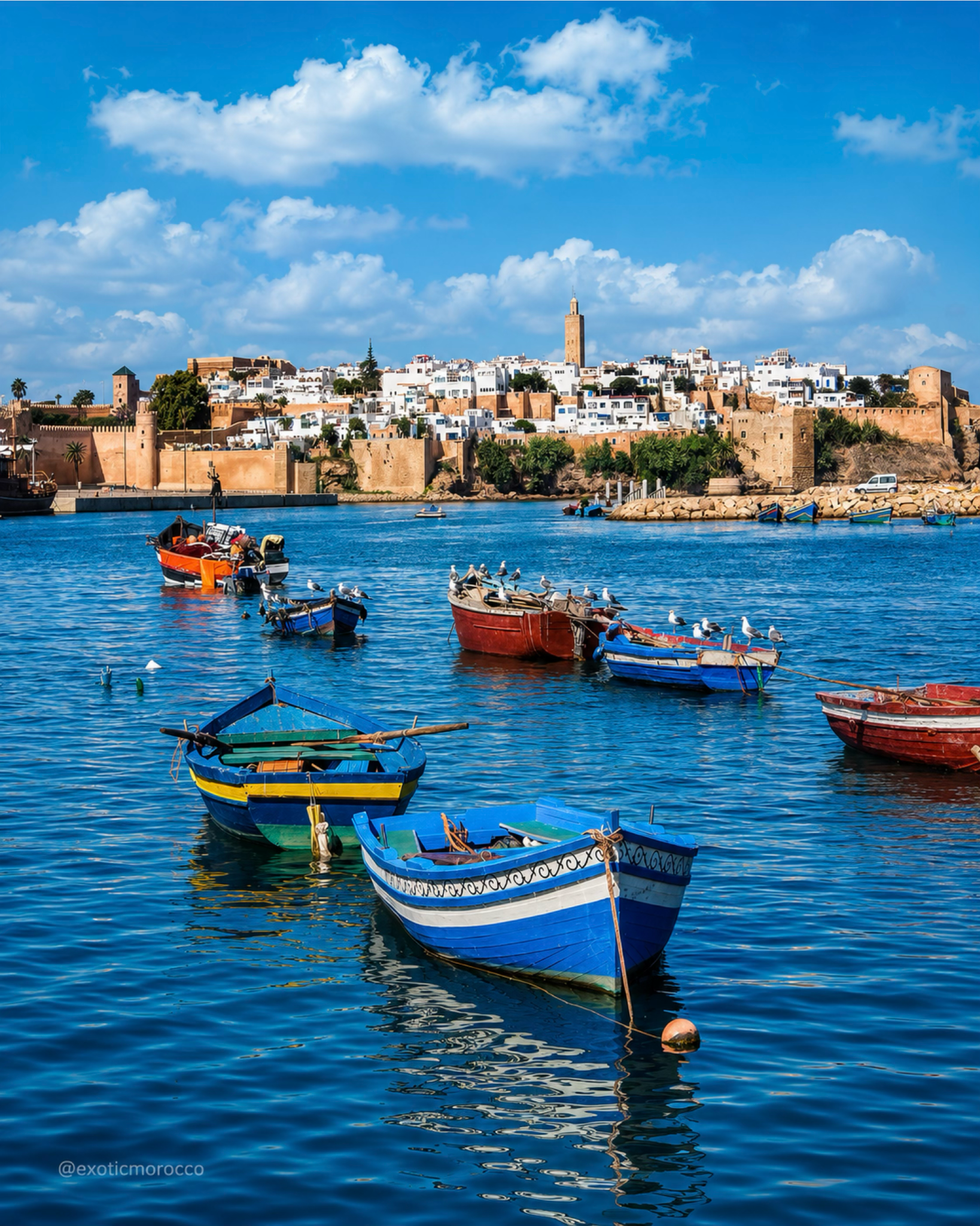 Boats on the Bouregreg with Rabat's walled skyline and minaret beyond