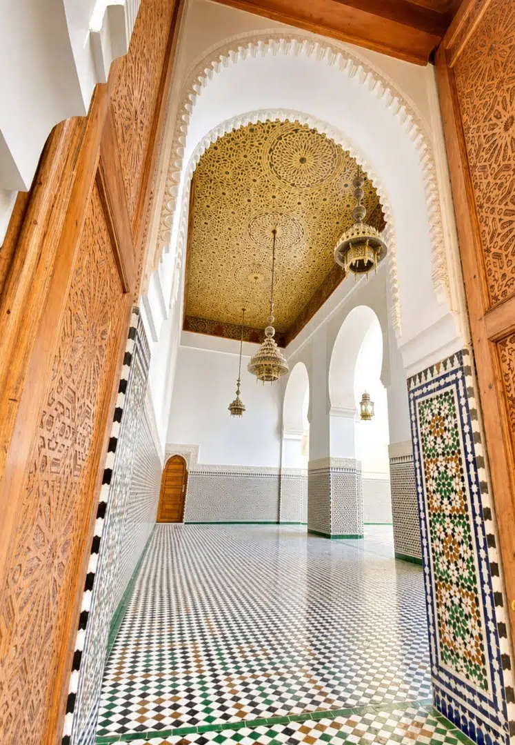 Moroccan architecture with carved wood, arches and mosaic flooring