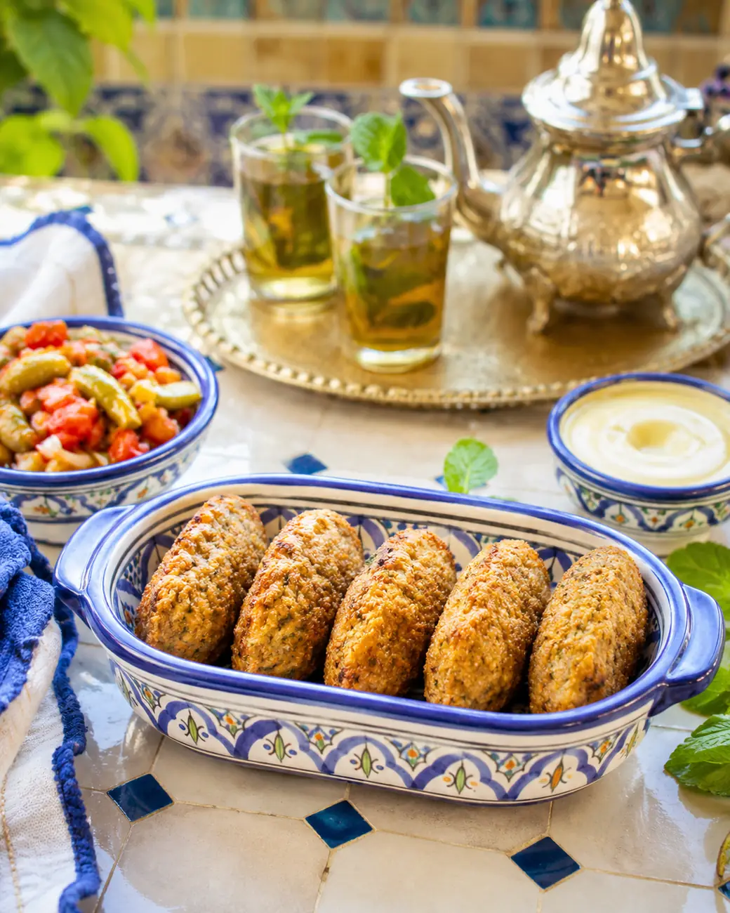 Maakouda | Moroccan recipe image | ExoticMorocco Maakouda potato croquettes in a blue ceramic dish — ExoticMorocco