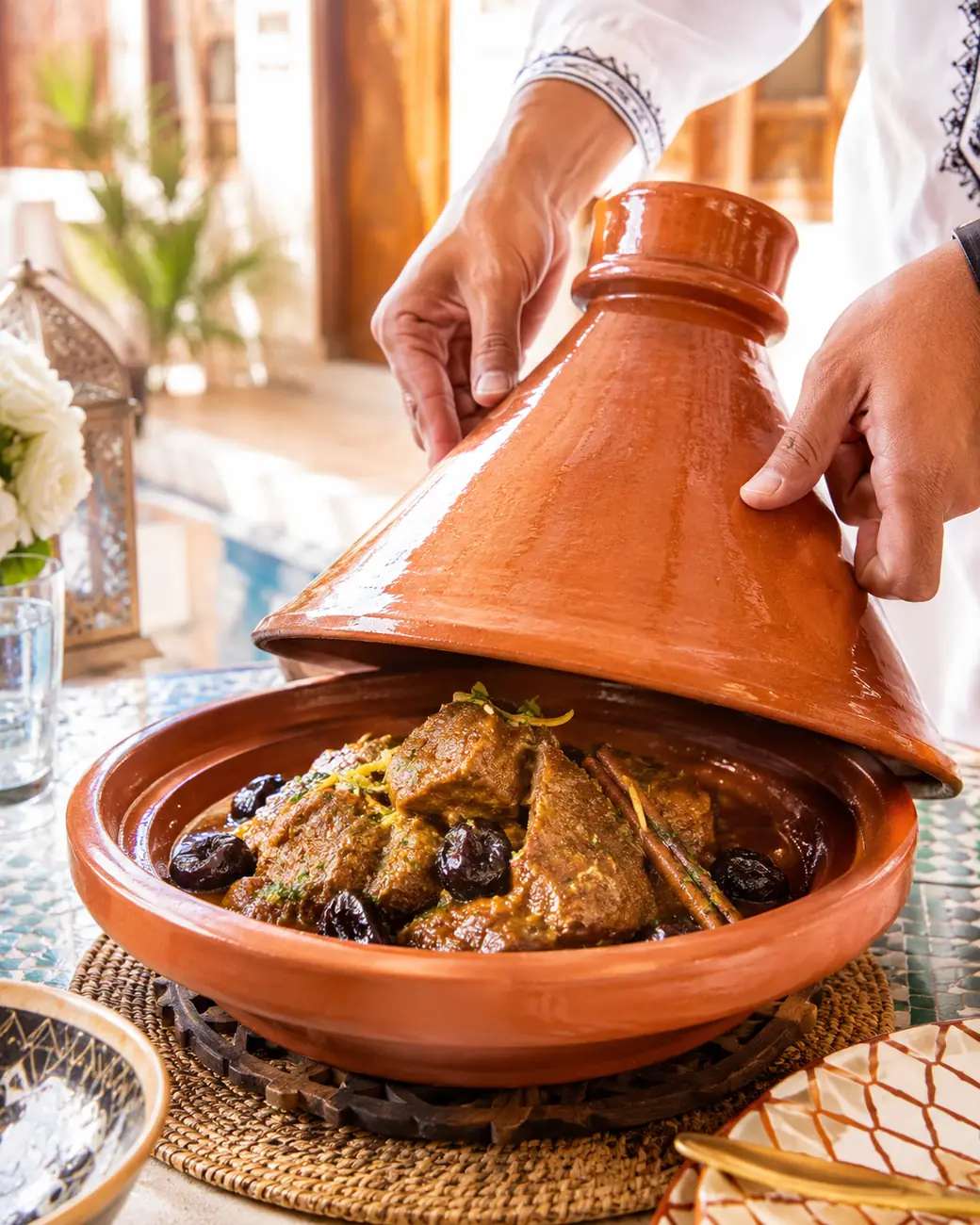 Moroccan tanjia tagine being opened — Exotic Morocco
