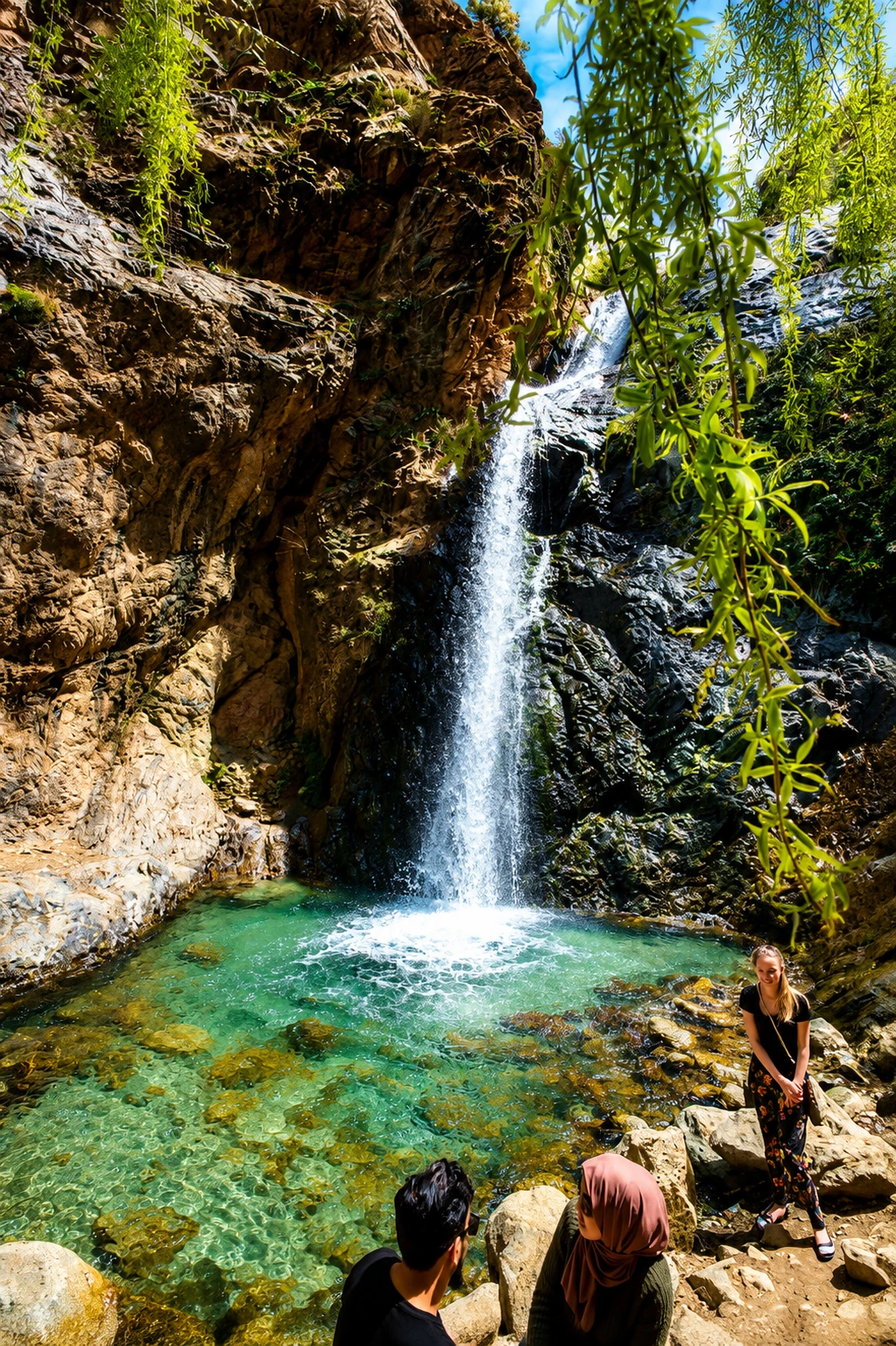 Setti Fatma Waterfalls with clear turquoise pool, rocky gorge and visitors in the Ourika Valley