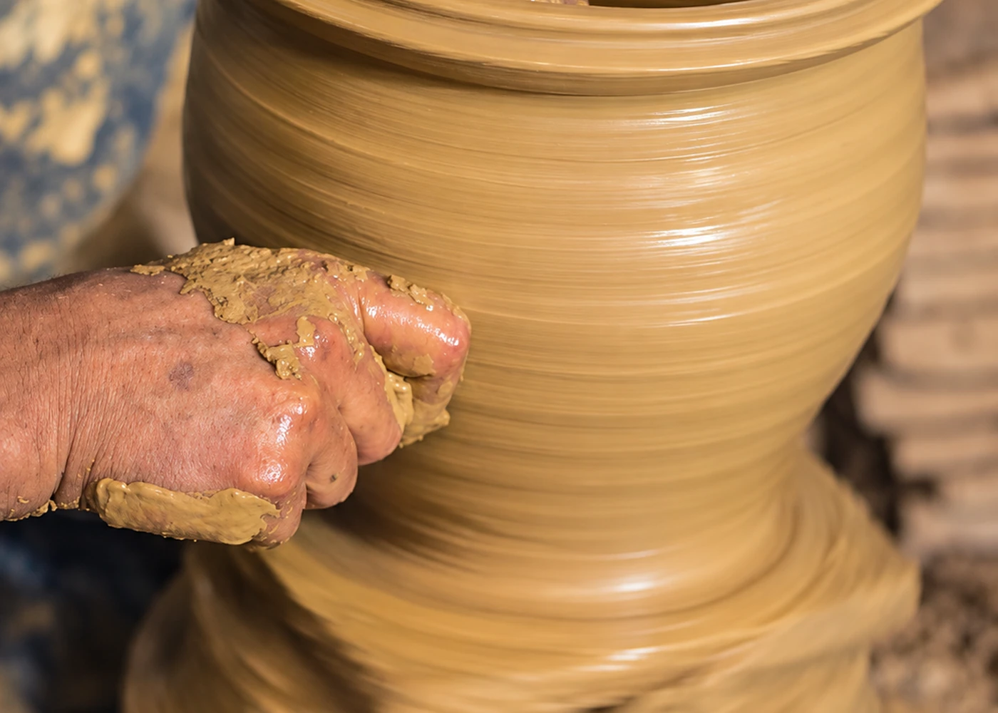 A potter’s hands working at the wheel