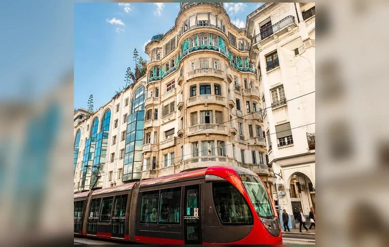 A red tram passing ornate buildings in central Casablanca