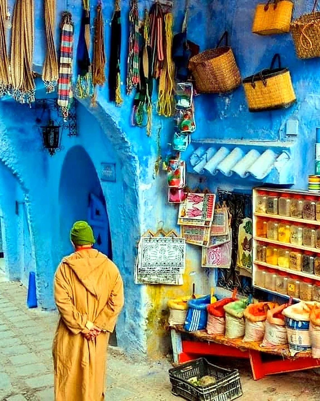 Craft shop and walking route in a blue Chefchaouen medina lane