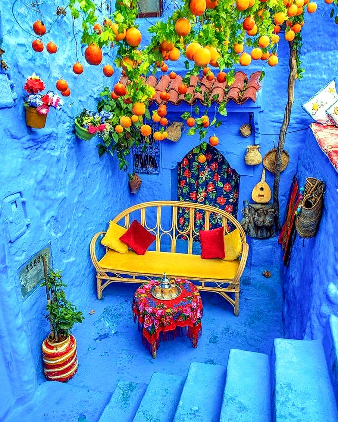 Blue Chefchaouen stairs with colourful flower pots