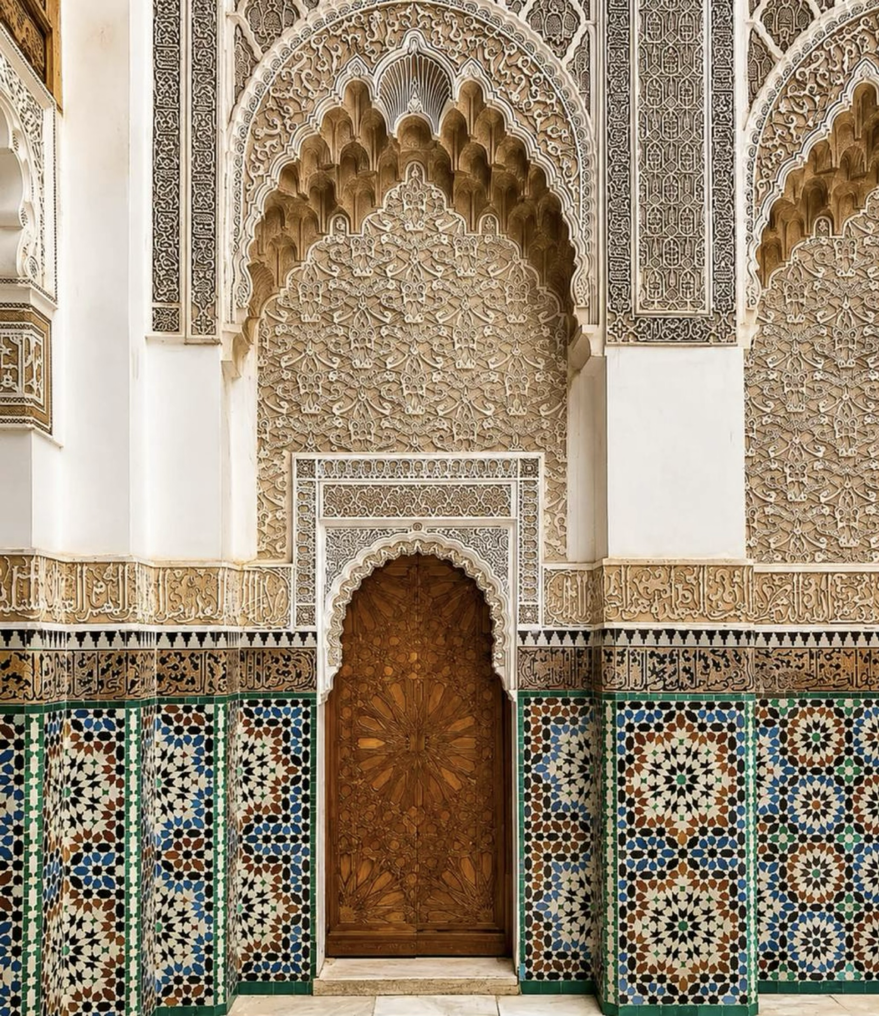 Ben Youssef Madrasa carved plaster, cedar doorway and zellige tilework