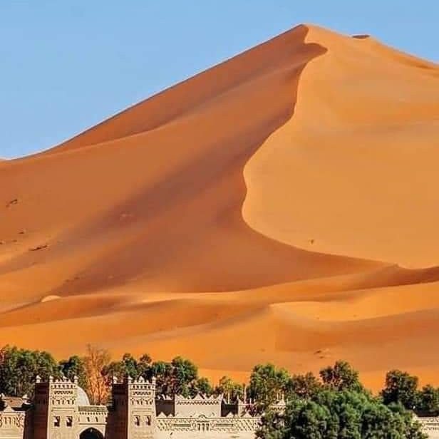 Desert dunes and kasbah edge in the Sahara
