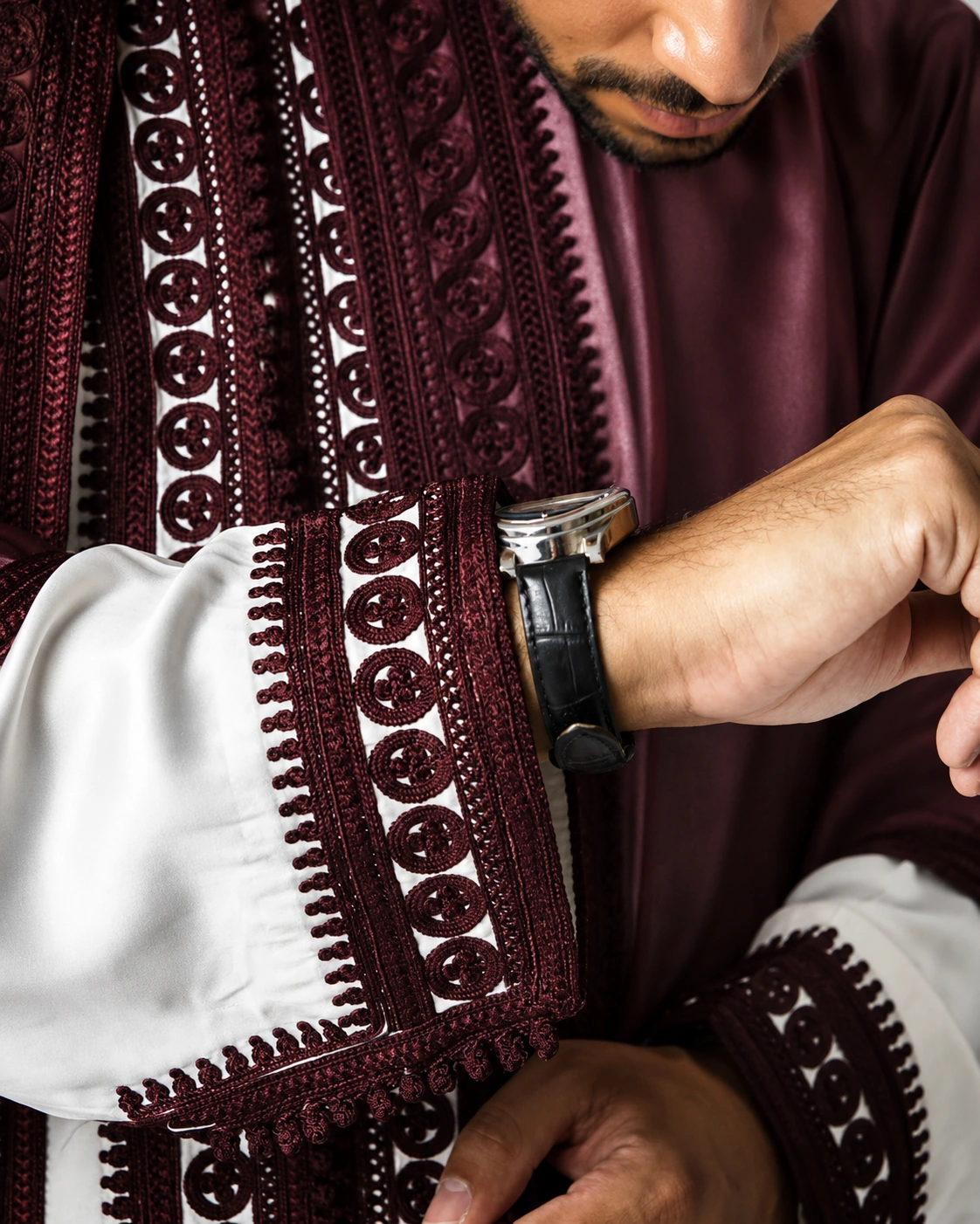 Close-up of burgundy Moroccan jabador embroidery and traditional cuff work