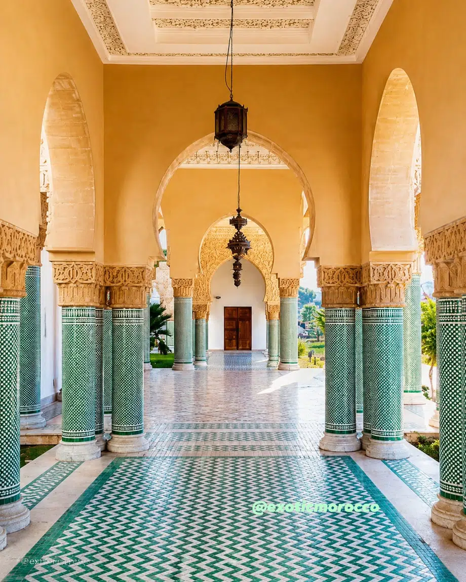 Moroccan architecture with arches, carved plaster, and green zellige columns