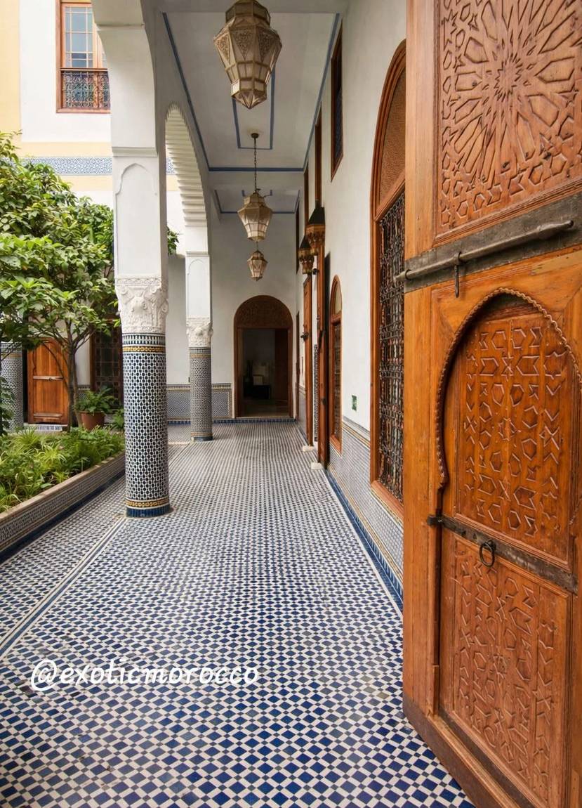 Moroccan corridor with carved wooden door and zellige floor