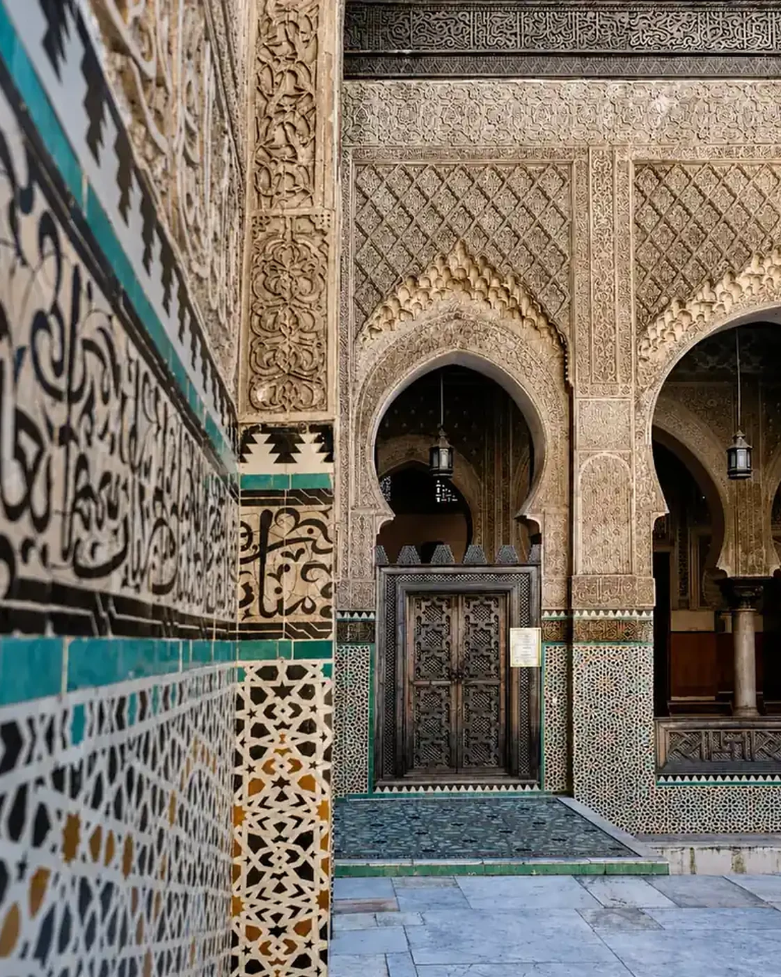 Tile, carved plaster and openings in a Fez madrasa.