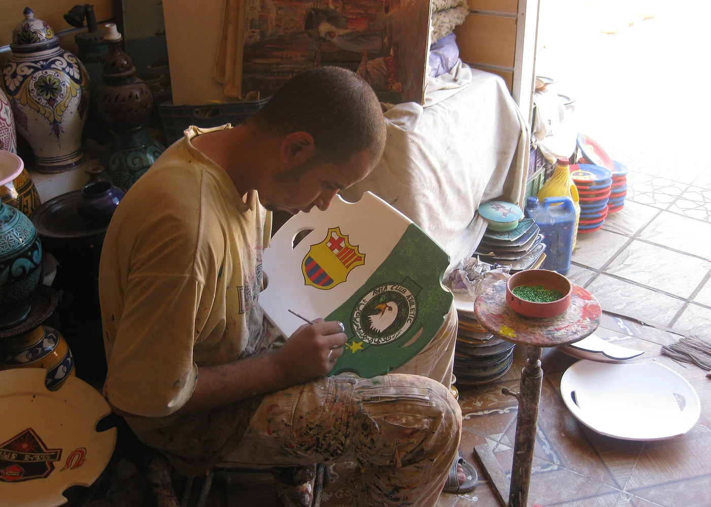 A craftsperson painting pottery in Safi.