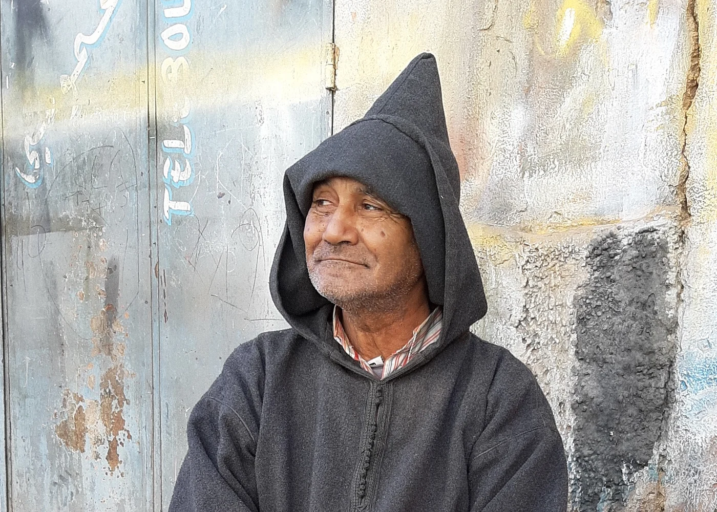 A man wearing a djellaba, photographed in Morocco.