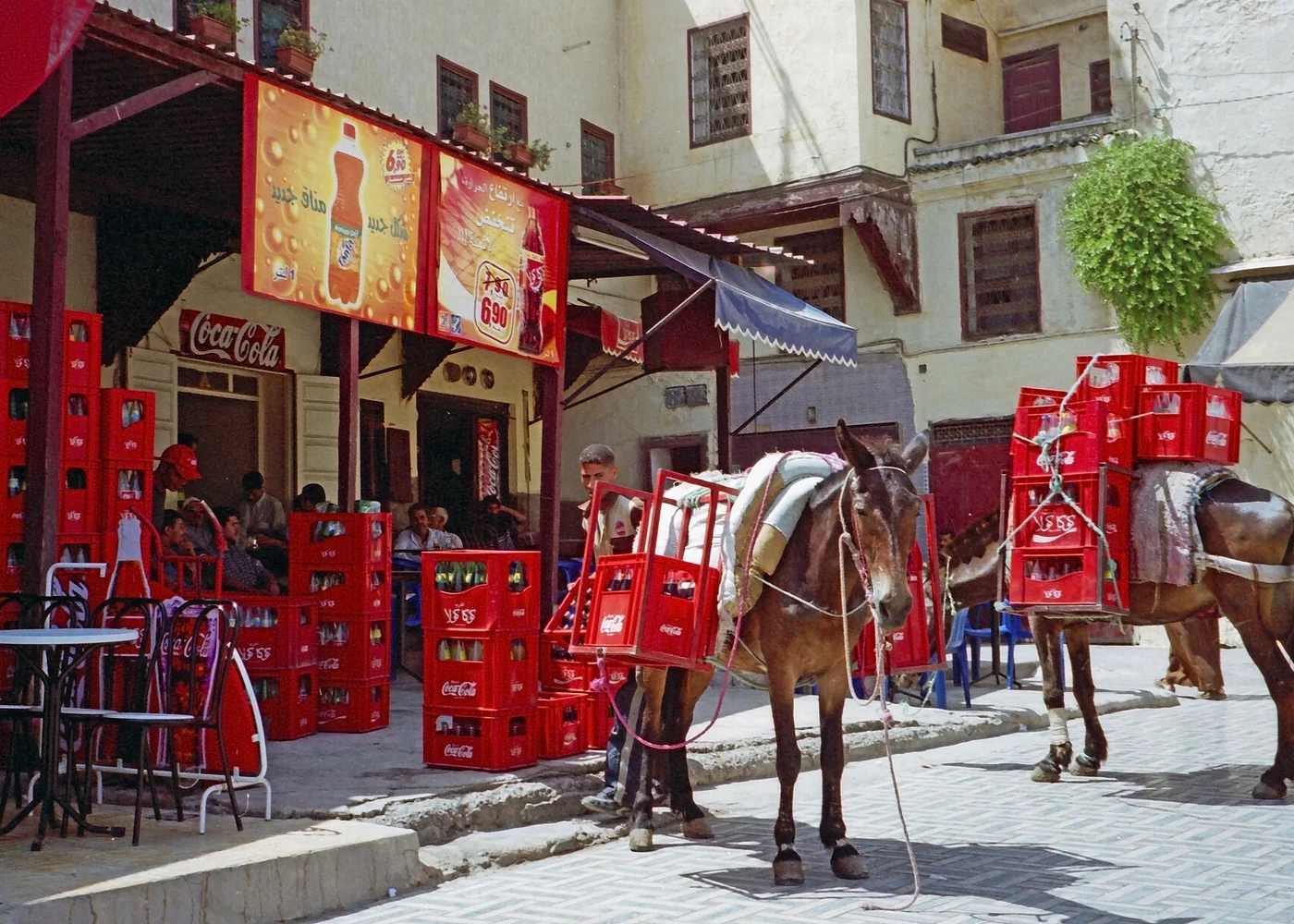 A historic film photograph of a drinks delivery in Fez.