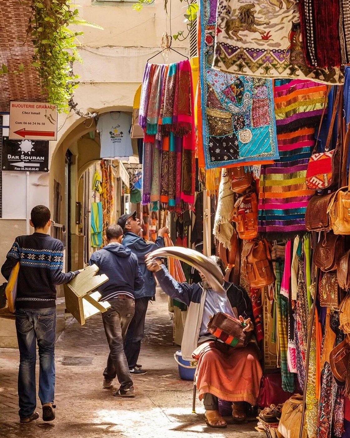 A market lane: conversation happens within daily work.