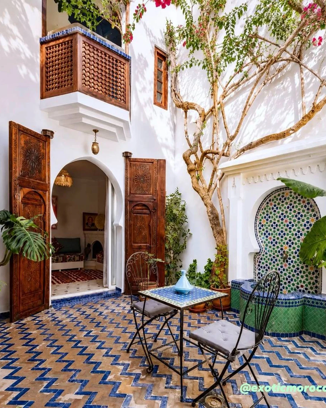 A domestic courtyard with planting and a tiled water feature.