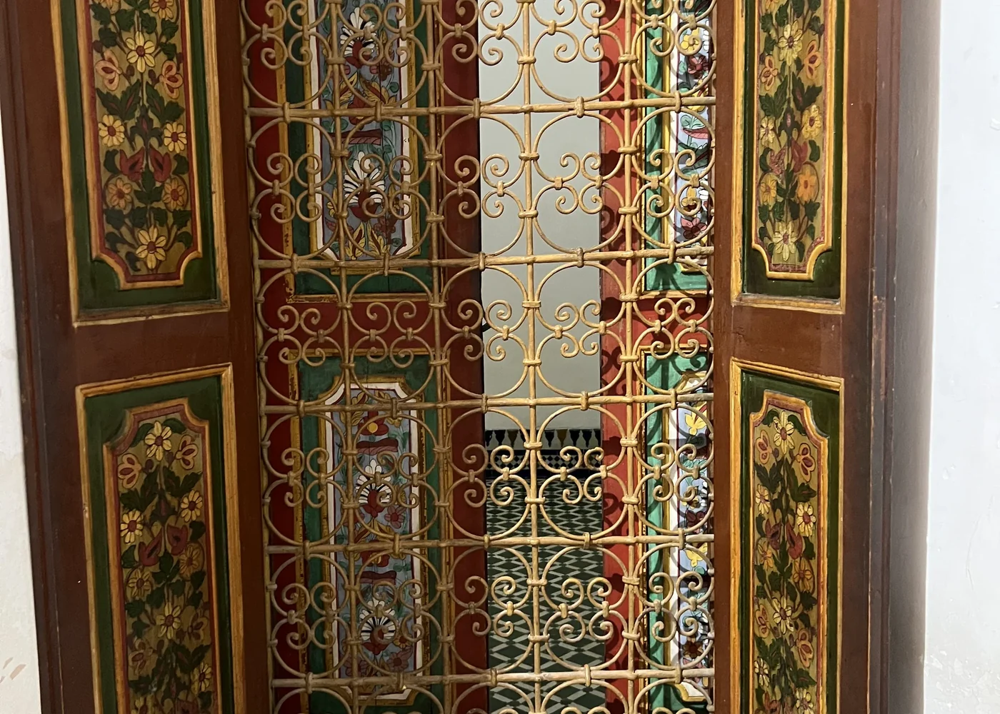 A carved door and stained glass at the Bahia Palace, Marrakech.