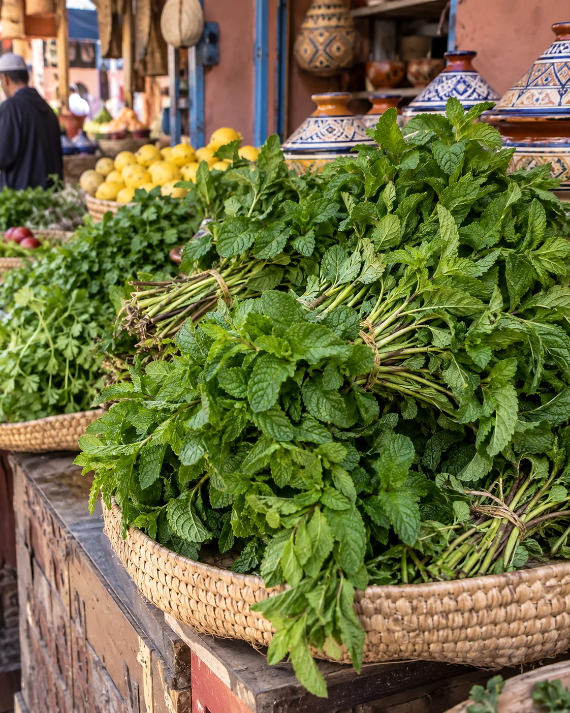 Baskets of herbs and spices in a colourful Moroccan market