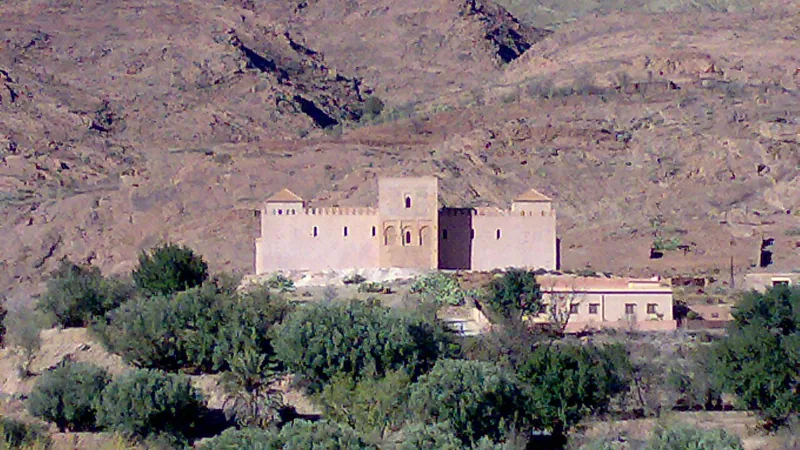 Historic documentary view of Tinmel Mosque in its mountain setting.