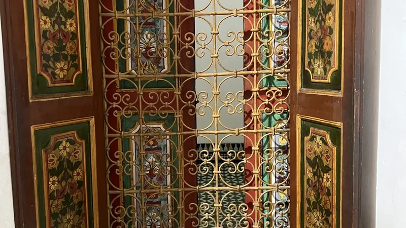 Carved door and stained glass at the Bahia Palace, Marrakech.