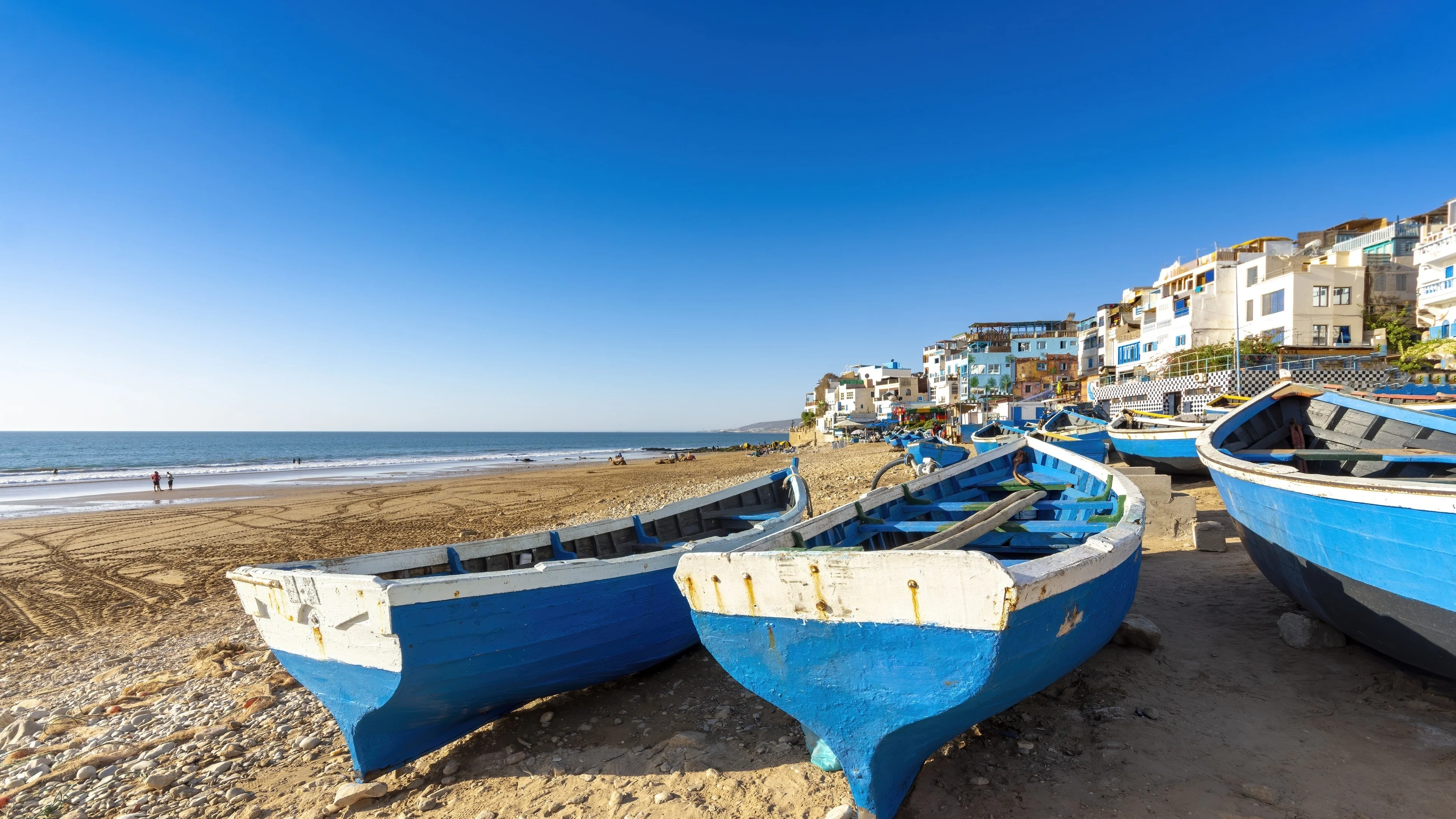 Blue fishing boats on the beach at Taghazout near Agadir