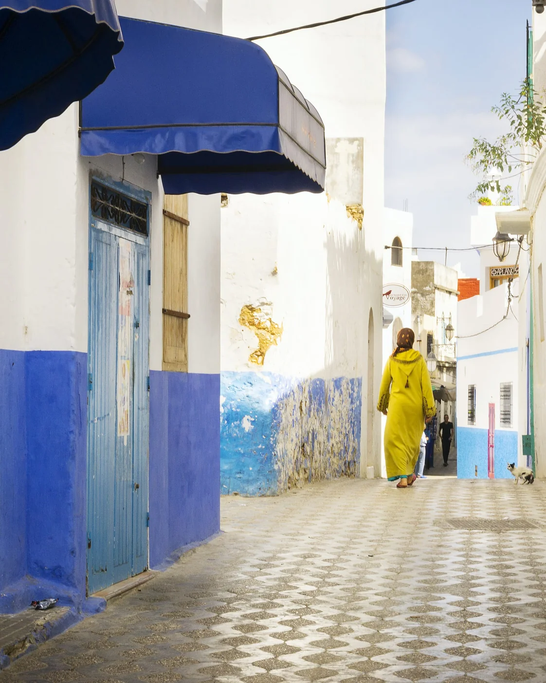 A residential lane in Asilah: doorways and daily routines deserve space.