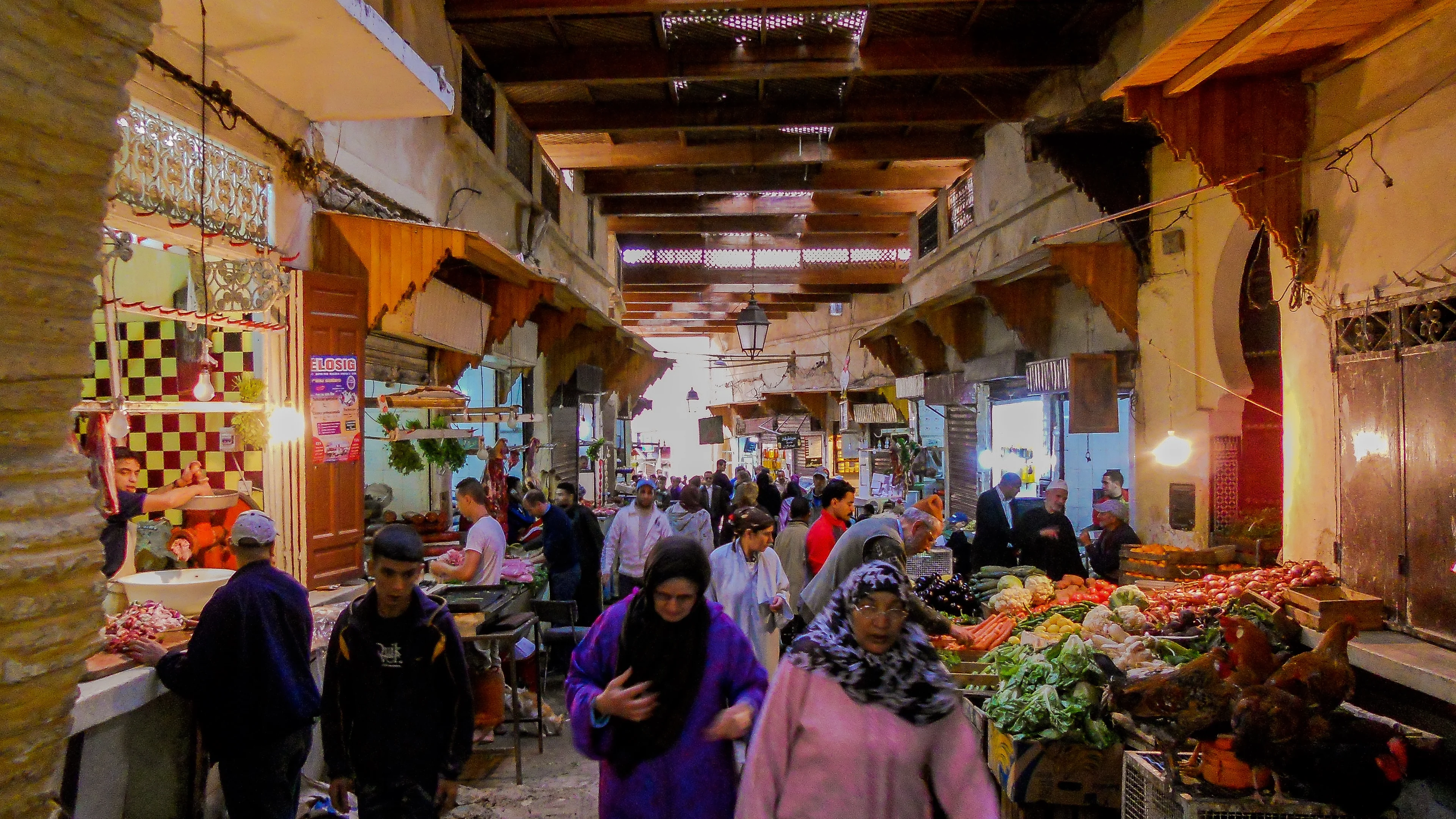 Everyday shopping and produce stalls in a covered Fès market