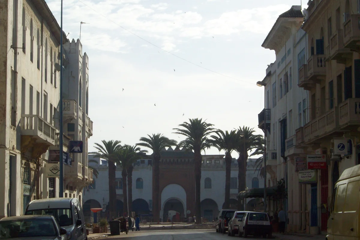 An avenue leading towards an arched gateway in Larache