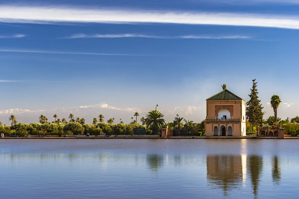 The Menara pavilion, water and palms beneath a broad Marrakech sky
