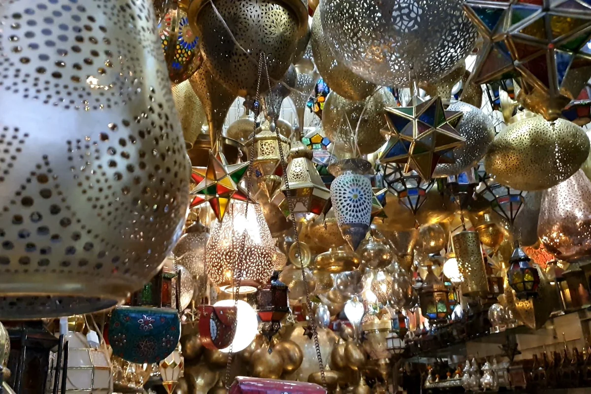 Metal lamps and perforated lanterns displayed in a Marrakech souk