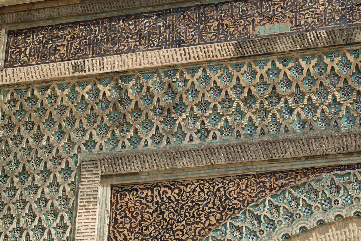 Geometric tilework and carved bands on Bab Mansour in Meknès