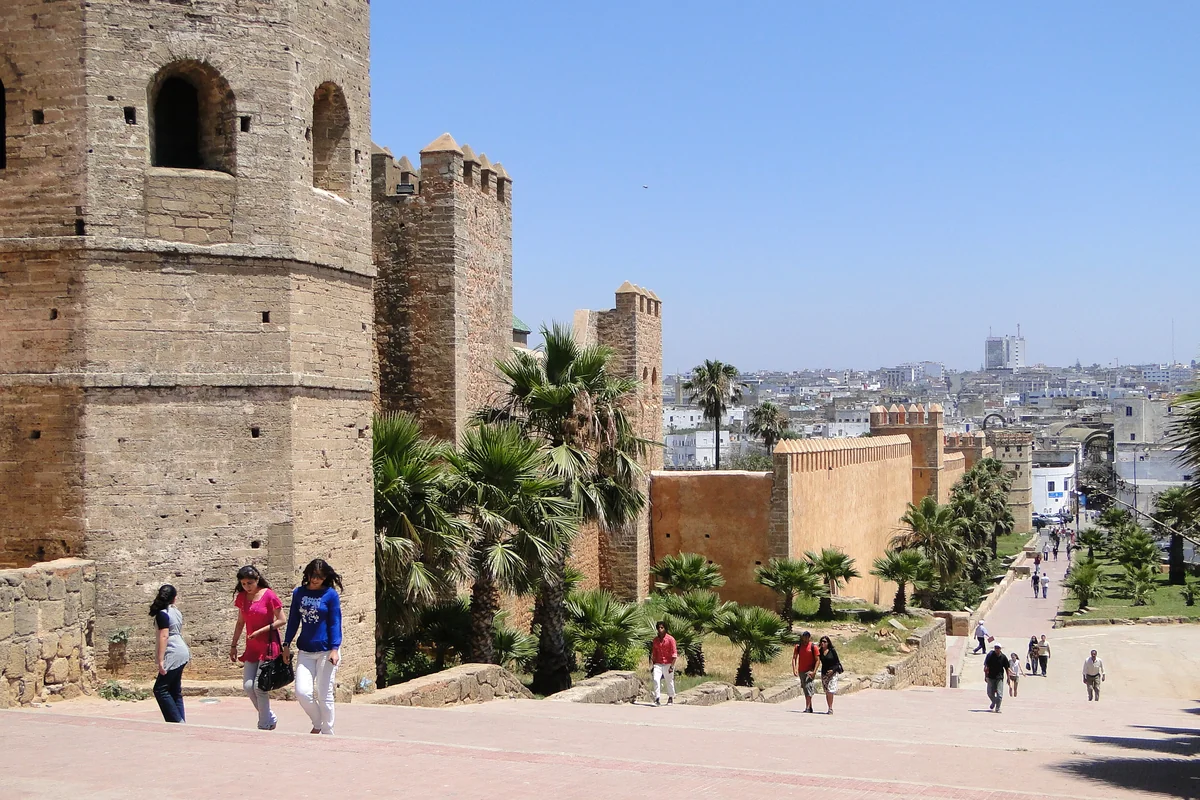 Visitors walking beside the monumental walls of Rabat's Udayas