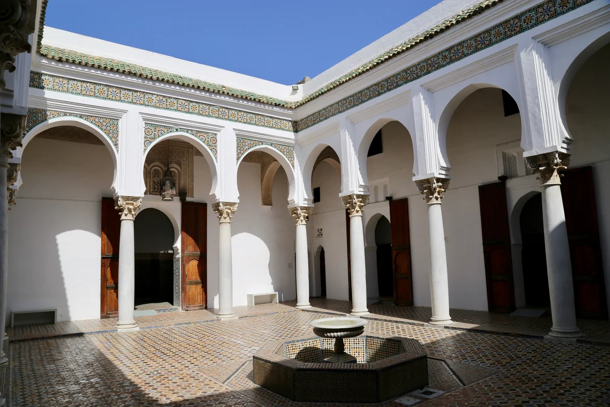 White arcades around a quiet courtyard in Tangier