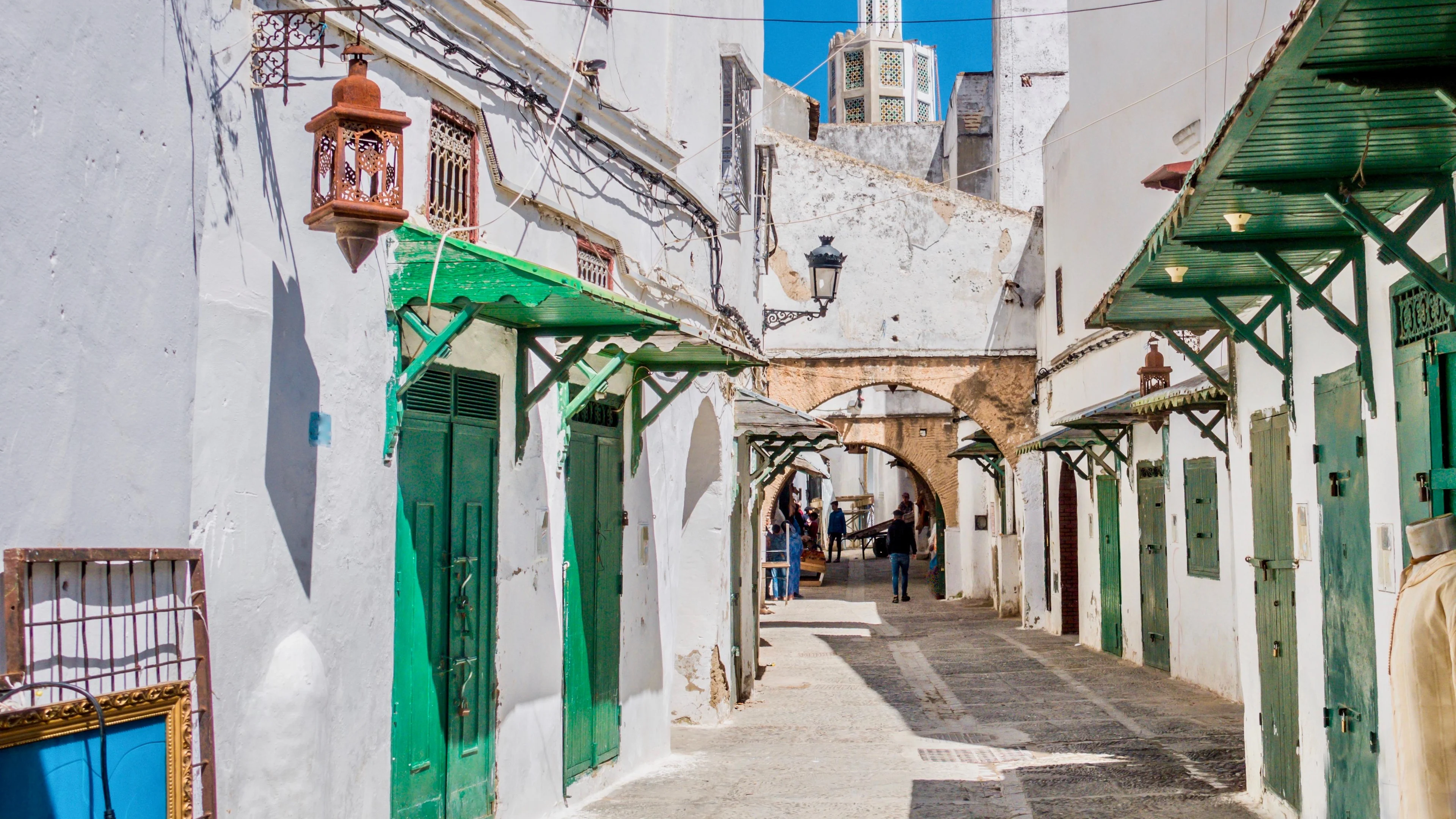 A quiet medina street with green doors in Tetouan