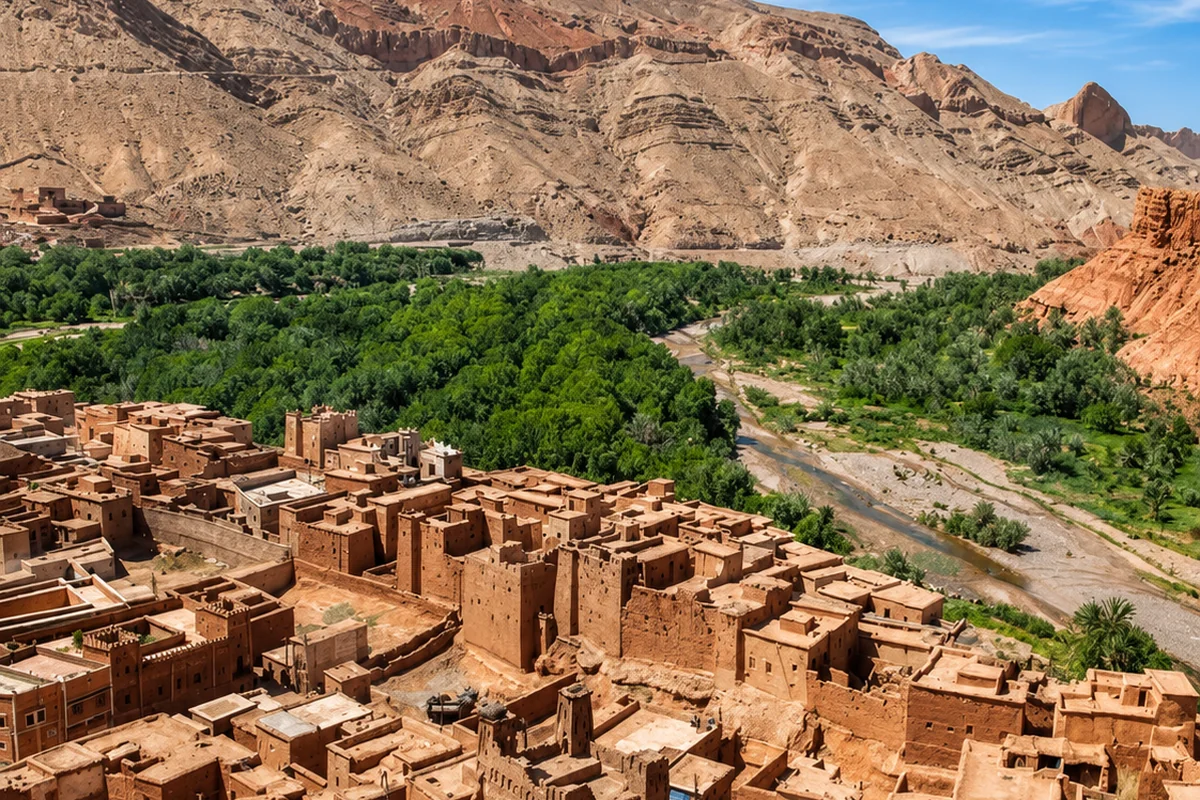 Earthen buildings beside the palm-filled Drâa Valley