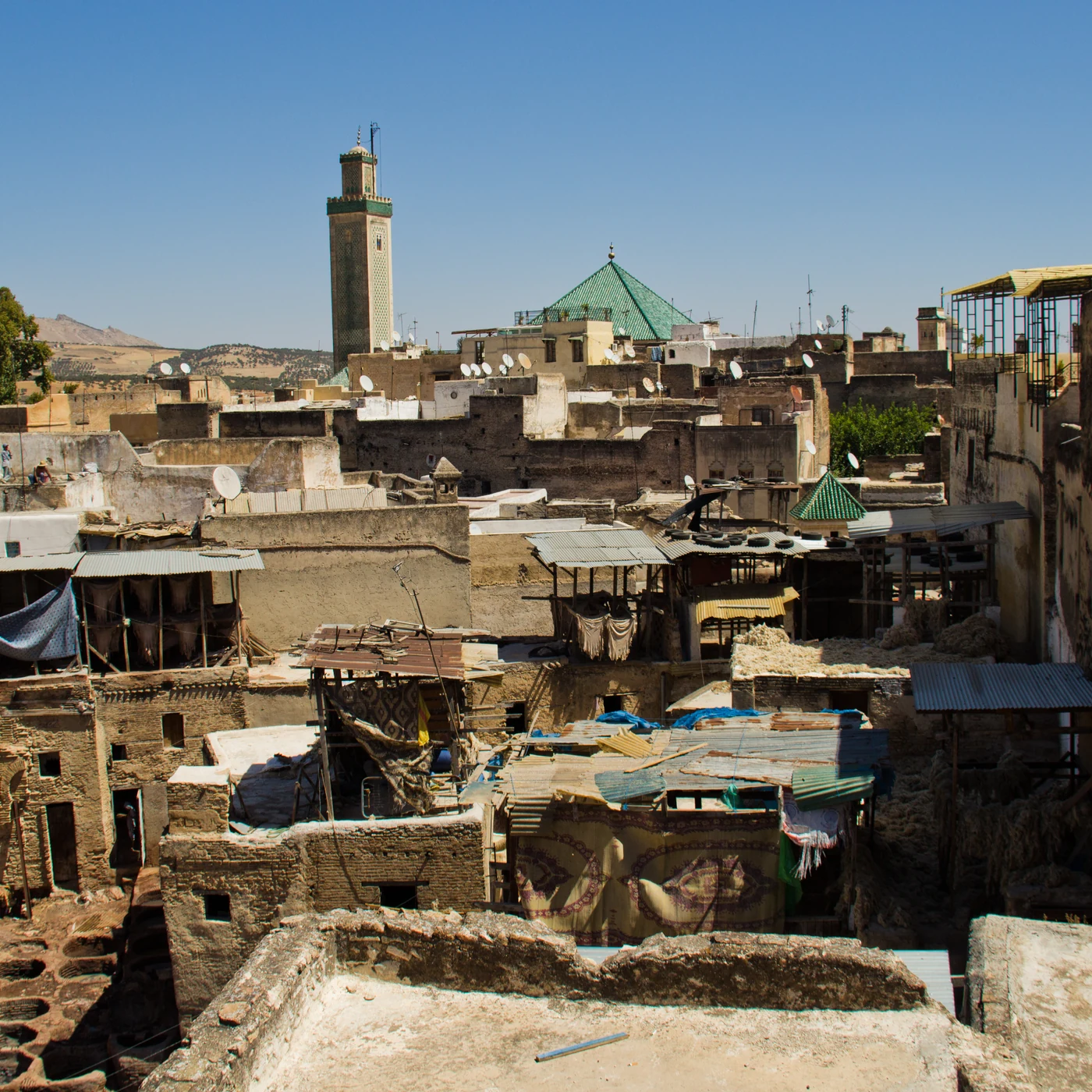 Roofs, a minaret and the working tannery area within the medina of Fès.