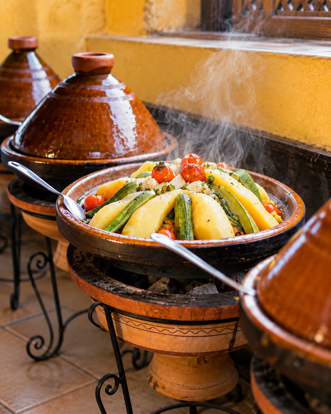 A vegetable tagine steaming gently above a traditional clay brazier