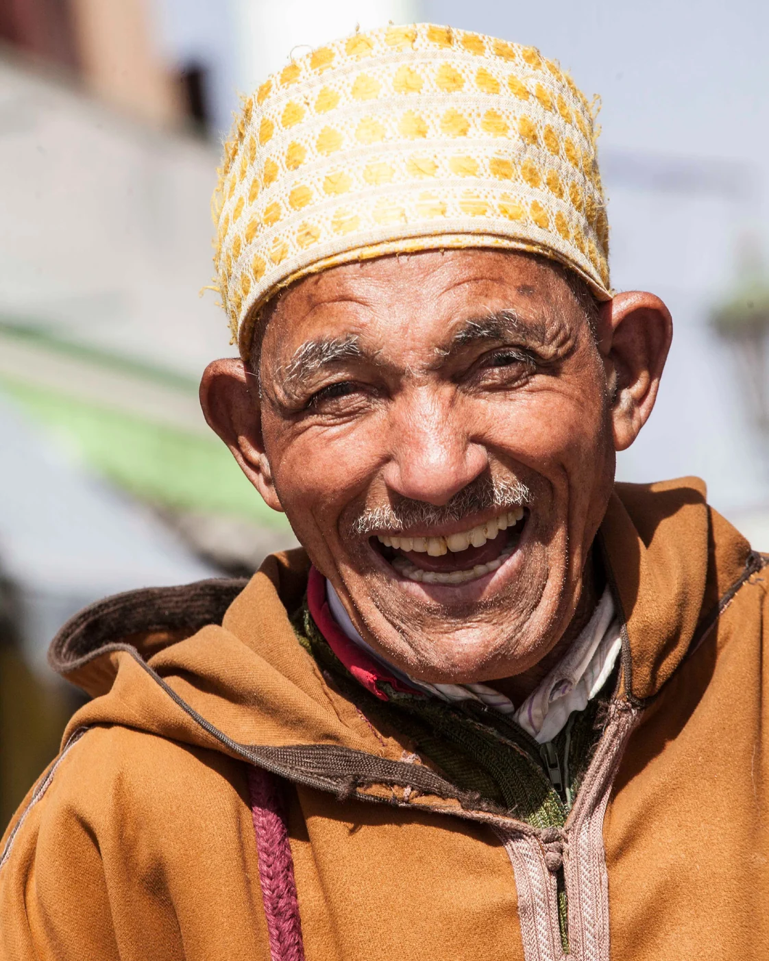 A portrait from the Exotic Morocco library: a hood, a cap and the expressive colour of everyday dress.