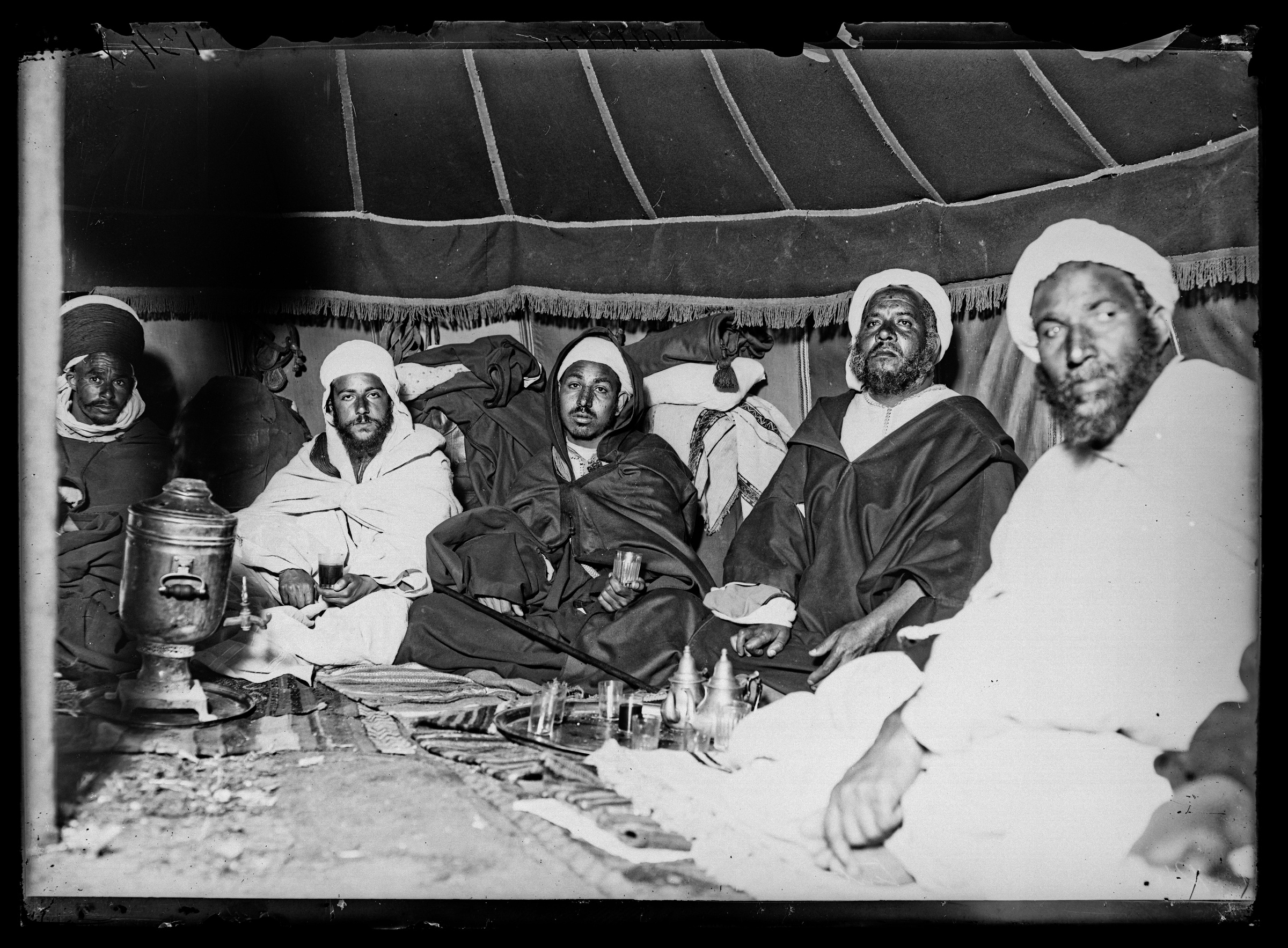 Archival photograph of a Boujad caid and companions inside a tent, 1913