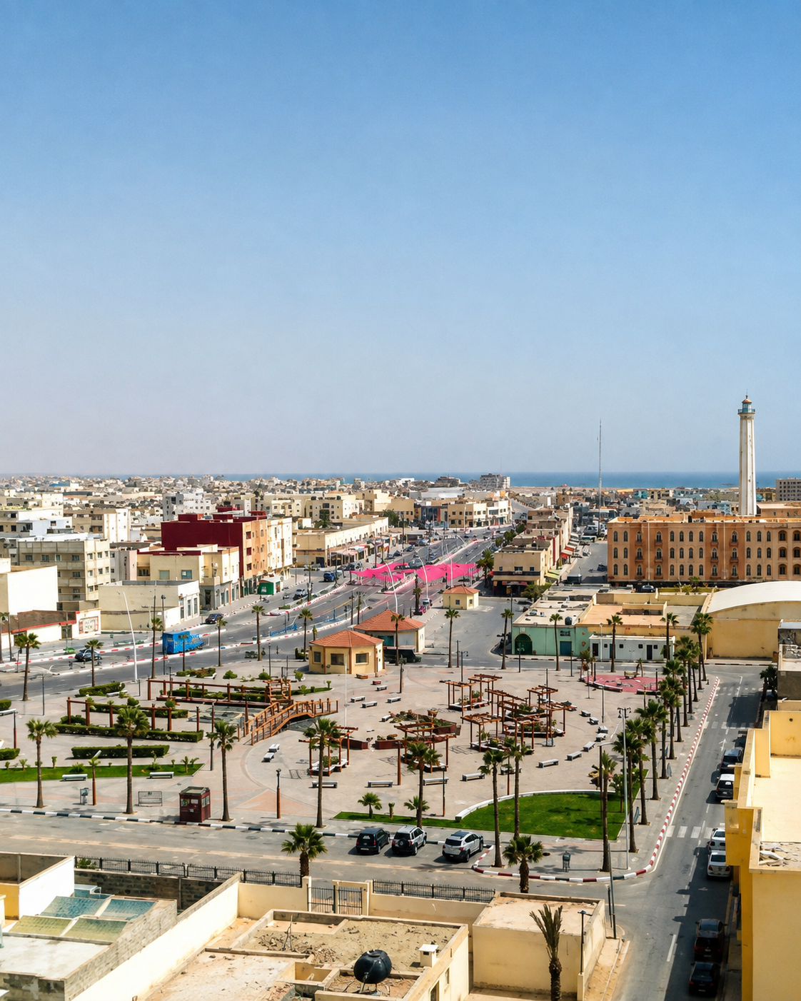 Boujdour public square and low-rise cityscape with the lighthouse near the Atlantic horizon