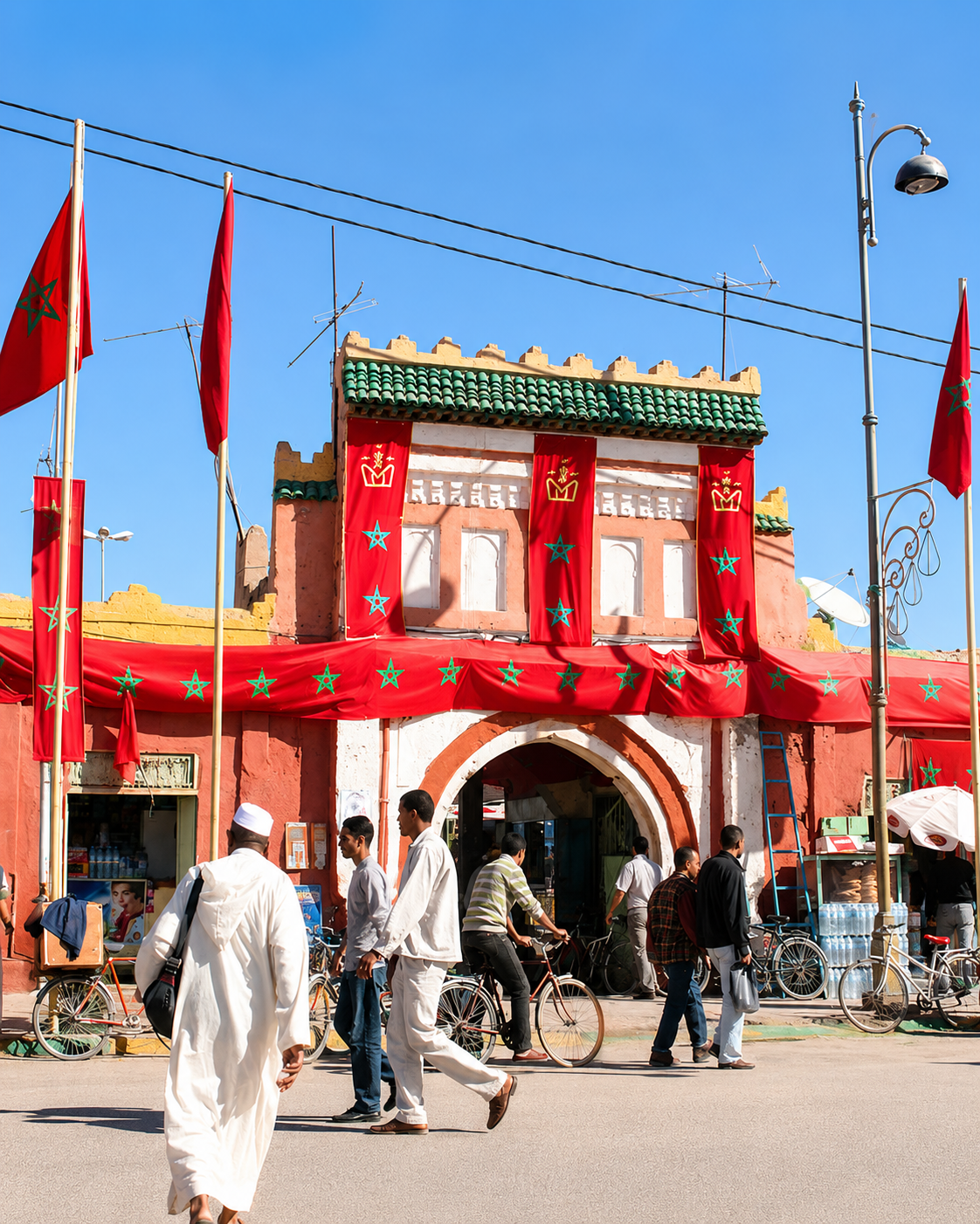 Rissani’s red monumental gateway, green tiled roof and passing market traffic