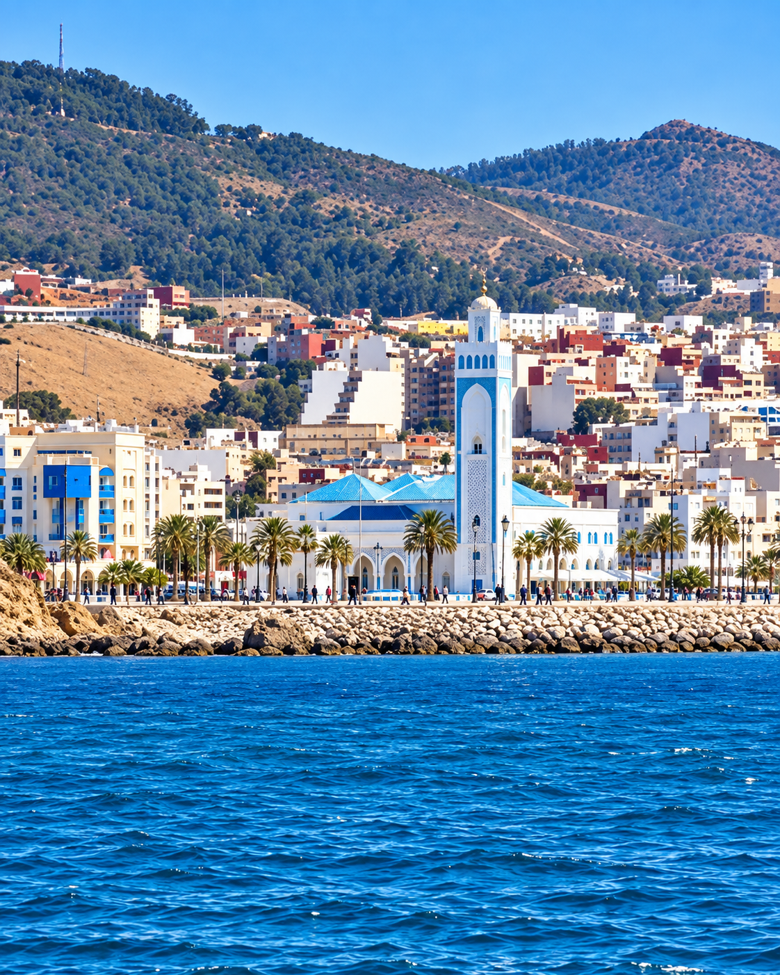 Fnideq seafront mosque and hillside neighbourhoods seen across the water
