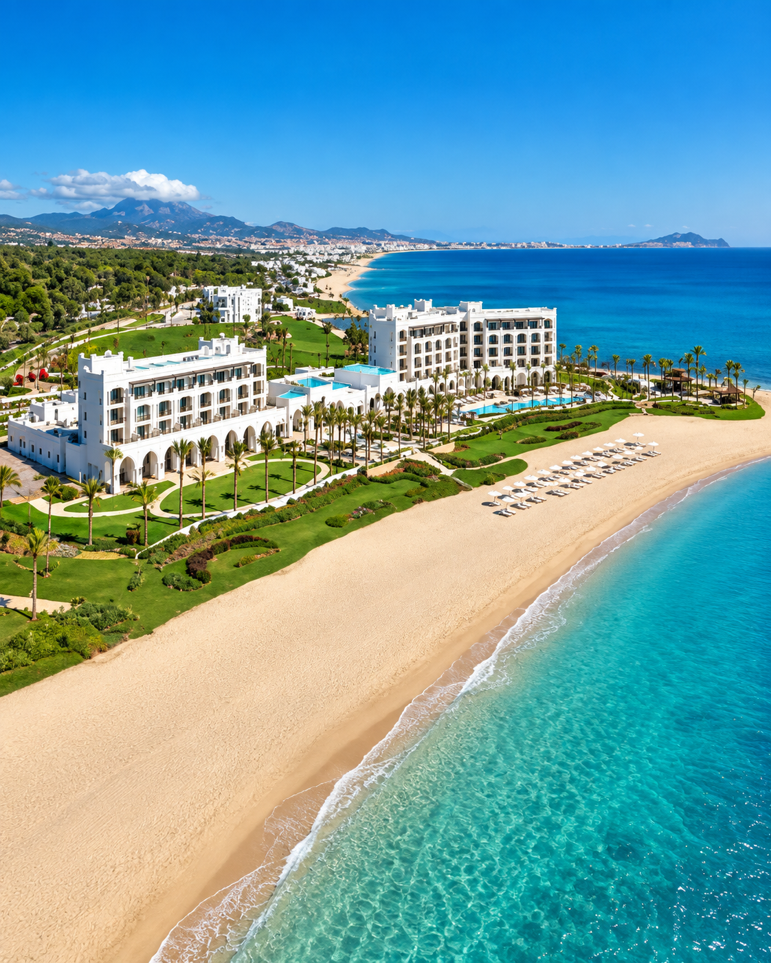 Beachfront hotel, gardens and turquoise sea along Tamuda Bay