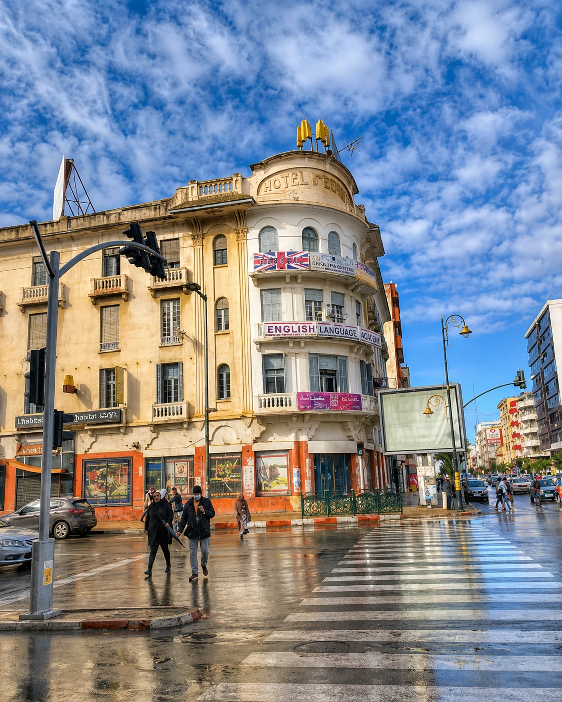 Historic Hotel de France building on a Kenitra street corner after rain