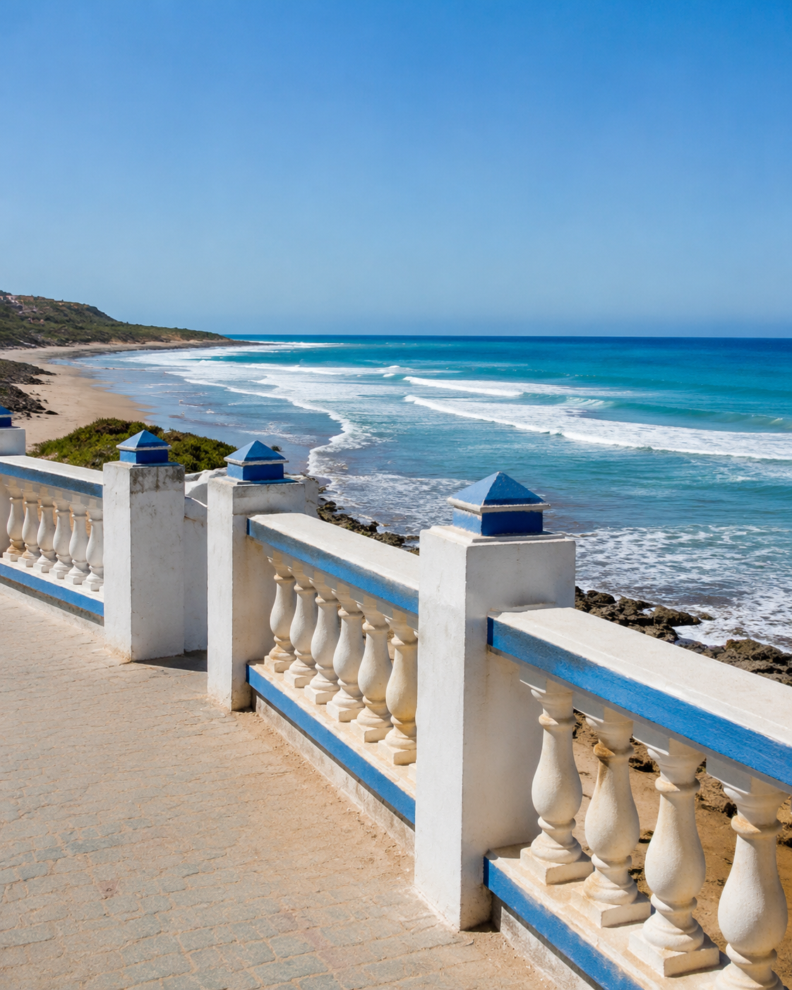 Blue and white balustrade overlooking Atlantic surf at Moulay Bouslham
